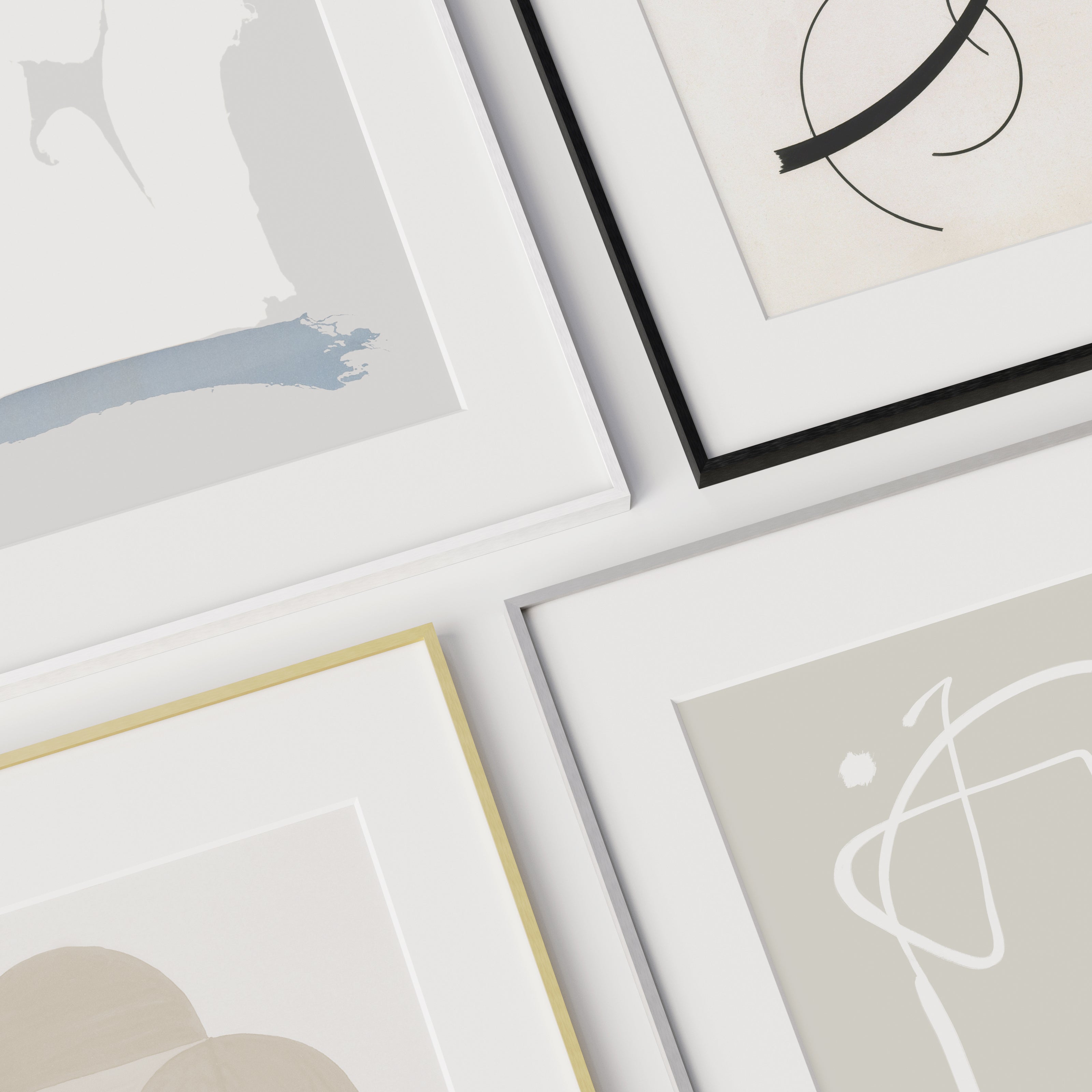 Collection of metal framed art prints on a light surface