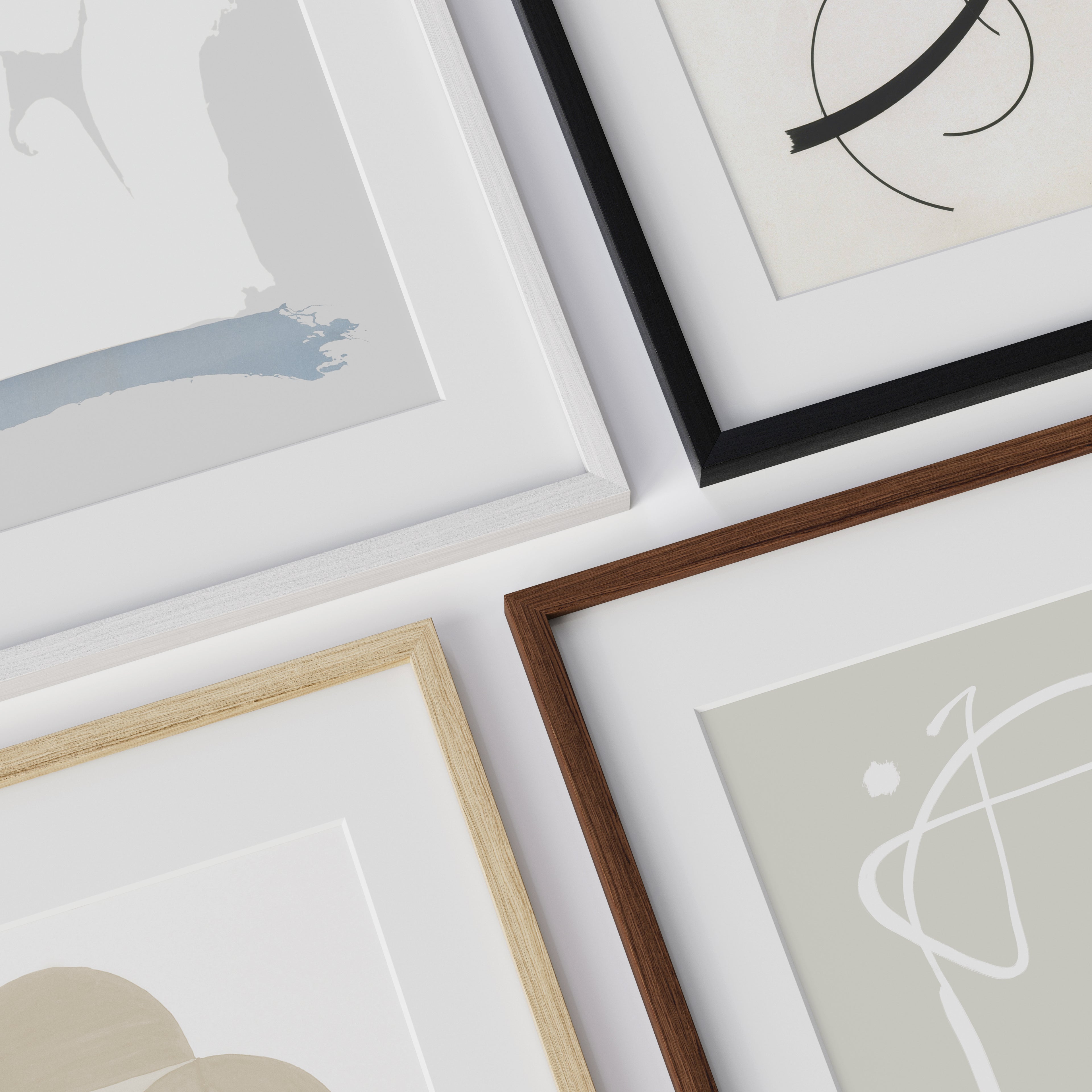 Collection of real wood framed artworks on a light background