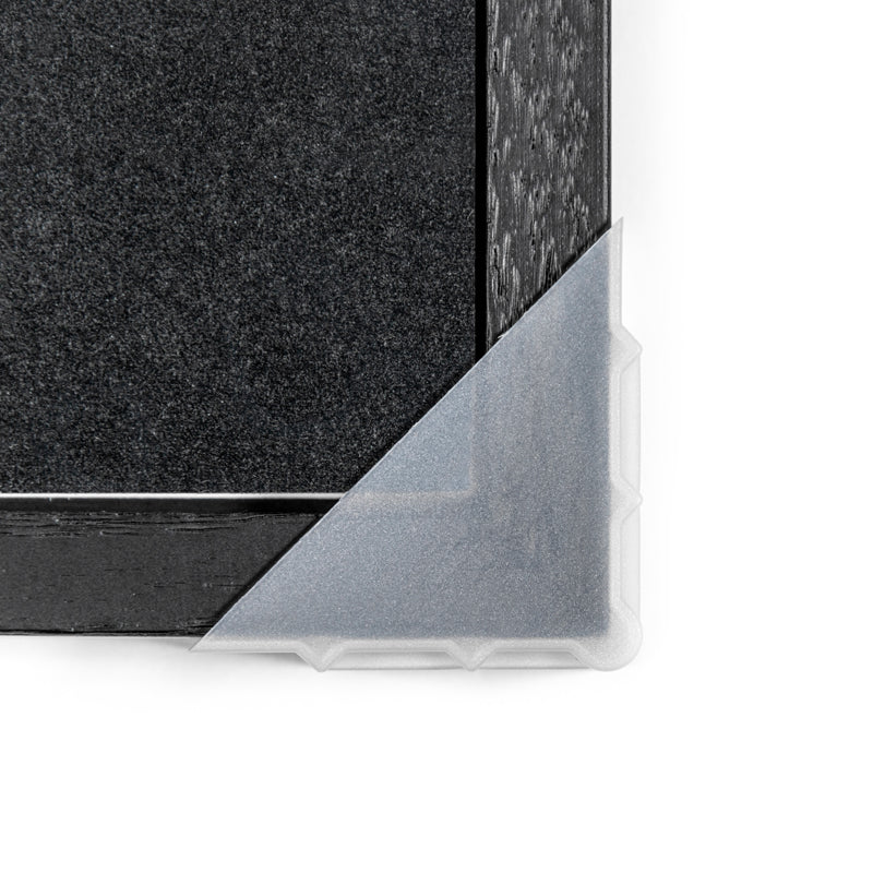 Clear protective film on a black surface with a textured pattern