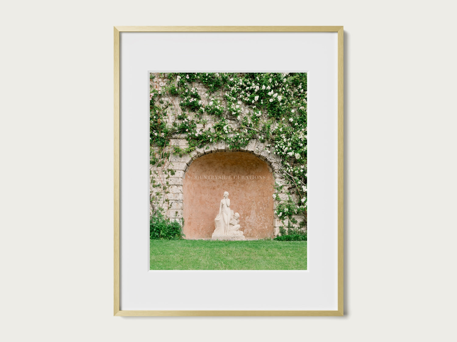 European courtyard photograph of a classical statue within a textured stone alcove covered in climbing plants.